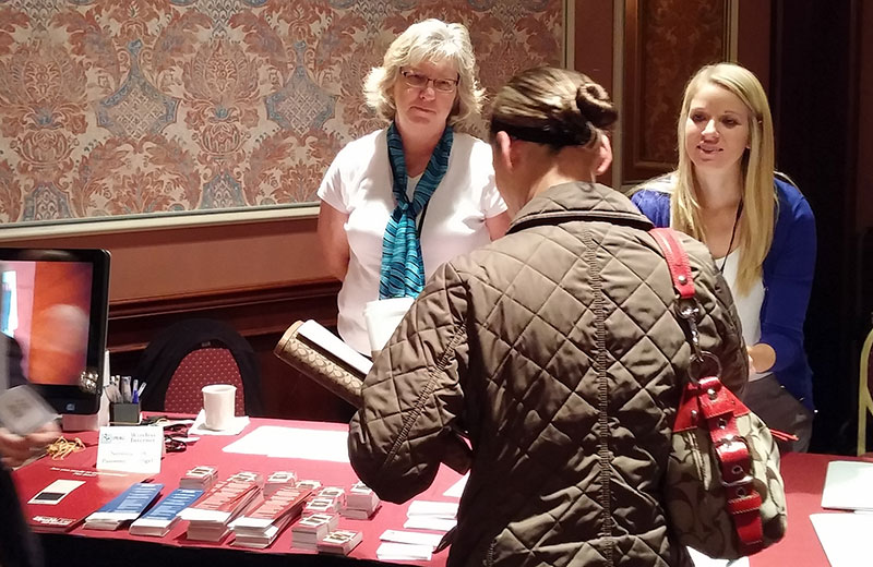 UW-CTRI Outreach team members Sandy Keller (left, with the scarf) and Amy Skora (right) staff the booth at the Days of Learning.