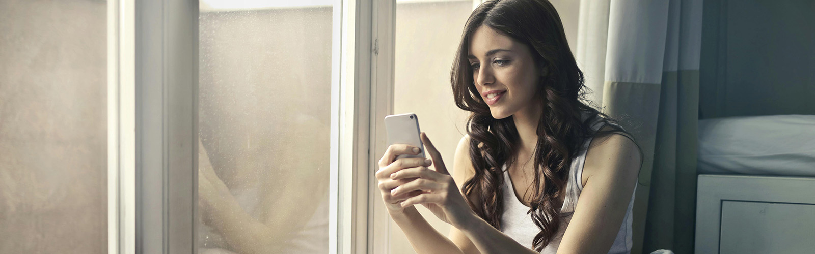 Young woman looks at her phone