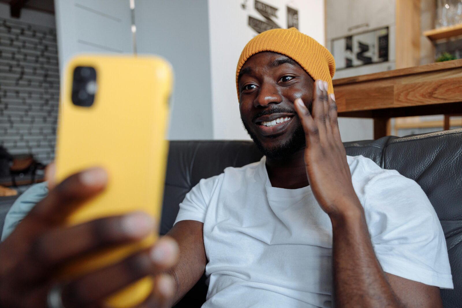 Man looks at his phone and smiles