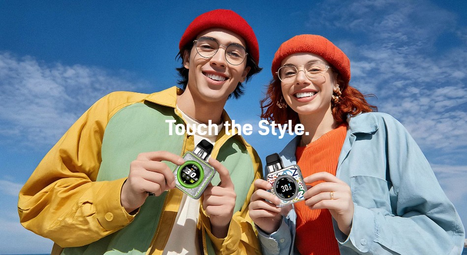 Two young adults hold up vape devices that resemble Apple watches